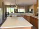 Spacious kitchen with a large island, quartz countertops, and dining area view at 23034 N Pedregosa Dr, Sun City West, AZ 85375