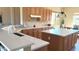A spacious kitchen with wood cabinets, quartz countertops, and a bright island at 23034 N Pedregosa Dr, Sun City West, AZ 85375
