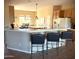 Bright kitchen featuring bar seating, stainless appliances, and an island sink at 23034 N Pedregosa Dr, Sun City West, AZ 85375