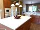 Kitchen island features a white marble countertop, with an oven and microwave built into surrounding cabinetry at 23034 N Pedregosa Dr, Sun City West, AZ 85375