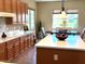 Bright kitchen features wood cabinets, marble countertops and a dining table near light-filled windows at 23034 N Pedregosa Dr, Sun City West, AZ 85375