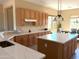 A spacious kitchen with wood cabinets, quartz countertops, and a bright island at 23034 N Pedregosa Dr, Sun City West, AZ 85375