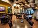 Spacious restaurant setting featuring a Southwestern aesthetic with a blend of textures and ample seating at Corte Bella at 23034 N Pedregosa Dr, Sun City West, AZ 85375