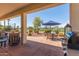 Landscaped back patio offers outdoor dining area and built-in grill at 23034 N Pedregosa N Dr, Sun City West, AZ 85375