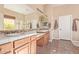 Bright bathroom featuring dual vanities, tile floors, and a large mirror, creating a functional space at 23034 N Pedregosa N Dr, Sun City West, AZ 85375