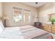 Bedroom boasts natural light, neutral paint, and brass-toned decor at 23034 N Pedregosa N Dr, Sun City West, AZ 85375