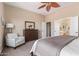 Comfortable bedroom with a king bed, dresser, and a view into the ensuite bathroom at 23034 N Pedregosa Dr, Sun City West, AZ 85375