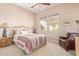 Bright bedroom with two windows, ceiling fan, and warm, neutral paint at 23034 N Pedregosa N Dr, Sun City West, AZ 85375