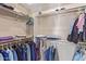 Walk-in closet features built-in shelves and rods for optimal organization at 23034 N Pedregosa N Dr, Sun City West, AZ 85375