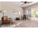 Dining area with natural light, ceiling fan, stylish artwork, and a view of the patio at 23034 N Pedregosa Dr, Sun City West, AZ 85375