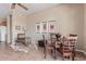 Dining area with dark wood furniture, stylish artwork, and a chair with hide rug at 23034 N Pedregosa N Dr, Sun City West, AZ 85375