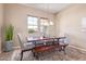 Dining room with lots of natural light, wooden table, chairs, and a bench at 23034 N Pedregosa Dr, Sun City West, AZ 85375