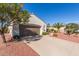 Paved driveway leading to a two-car garage with desert landscaping at 23034 N Pedregosa Dr, Sun City West, AZ 85375