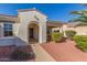 Inviting front entrance with an arched doorway and a covered porch at 23034 N Pedregosa Dr, Sun City West, AZ 85375