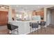 Kitchen with bar seating, tile countertops, and view of the breakfast nook at 23034 N Pedregosa Dr, Sun City West, AZ 85375