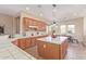 Kitchen with tile countertops, a center island, and a full view of the dining area at 23034 N Pedregosa Dr, Sun City West, AZ 85375