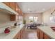 Bright kitchen with tile countertops, stainless steel appliances, and an adjacent dining area at 23034 N Pedregosa Dr, Sun City West, AZ 85375