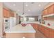 Kitchen featuring a large island with tile countertops, white appliances, and an open layout at 23034 N Pedregosa Dr, Sun City West, AZ 85375