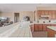 Kitchen featuring tile countertops, white appliances, and an open layout to living area at 23034 N Pedregosa Dr, Sun City West, AZ 85375