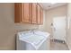 Laundry room features cabinetry above the washing machine and dryer at 23034 N Pedregosa Dr, Sun City West, AZ 85375