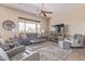 Spacious living room with comfortable seating, ceiling fans, and natural light at 23034 N Pedregosa Dr, Sun City West, AZ 85375