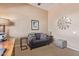 Stylish living room with a leather sofa, wooden desk, and a neutral color scheme, perfect for relaxation at 23034 N Pedregosa N Dr, Sun City West, AZ 85375