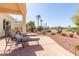 Inviting covered patio with comfortable lounge chairs and views of the landscaped backyard at 23034 N Pedregosa Dr, Sun City West, AZ 85375