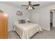 Bedroom featuring a ceiling fan, closet, flower artwork and comfy bed at 24108 N Nectar Ave, Florence, AZ 85132