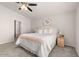 Bright bedroom features soft carpet, ceiling fan, and a serene, neutral color palette at 24108 N Nectar Ave, Florence, AZ 85132