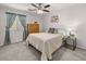 Bright bedroom with a ceiling fan, a dresser and a bedside table with a lamp at 24108 N Nectar Ave, Florence, AZ 85132