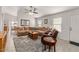 Bright and airy living room featuring a large sectional sofa, modern ceiling fan and hardwood floors at 24108 N Nectar Ave, Florence, AZ 85132