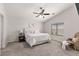 Serene main bedroom with neutral tones, large windows and a comfortable seating area at 24108 N Nectar Ave, Florence, AZ 85132