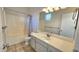 Bathroom features a large mirror, a shower/tub, and a sink with cabinets at 2541 S Sunnyvale Ave, Gilbert, AZ 85295