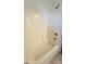 Bright bathroom features a bathtub with tiled walls and a shower head fixture at 2541 S Sunnyvale Ave, Gilbert, AZ 85295