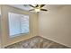 A bedroom with neutral colored carpet and a large window with horizontal blinds at 2541 S Sunnyvale Ave, Gilbert, AZ 85295