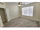 The bedroom features a ceiling fan, window, carpet, and an entrance to another room at 2541 S Sunnyvale Ave, Gilbert, AZ 85295