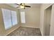 A bedroom with neutral colored carpet and a large window with horizontal blinds at 2541 S Sunnyvale Ave, Gilbert, AZ 85295