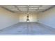 Spacious garage with concrete floor, a water heater, and ample room for vehicles and storage at 2541 S Sunnyvale Ave, Gilbert, AZ 85295