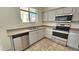 Close up of the updated kitchen featuring stainless steel appliances, and light gray cabinets at 2541 S Sunnyvale Ave, Gilbert, AZ 85295