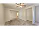 Open-concept living area with neutral carpet, white walls, and ceiling fan, provides a blank canvas for personalization at 2541 S Sunnyvale Ave, Gilbert, AZ 85295