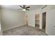 Main bedroom with a closet entrance, ceiling fan, carpet, and natural light at 2541 S Sunnyvale Ave, Gilbert, AZ 85295