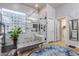 Luxurious bathroom featuring a glass-enclosed shower, elegant bench, and stylish tile work with a decorative window at 2571 E Balsam Ct, Chandler, AZ 85286