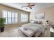Bright bedroom with large windows, a comfortable bed, and stylish decor for relaxation at 2571 E Balsam Ct, Chandler, AZ 85286