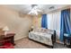 Cozy bedroom featuring a bed, a ceiling fan, and carpeted floors at 2571 E Balsam Ct, Chandler, AZ 85286