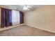 Bedroom featuring a ceiling fan, carpeted floors and colorful drapes at 2571 E Balsam Ct, Chandler, AZ 85286