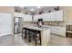 Bright kitchen featuring a granite island, stainless steel appliances, and a chef statue for added charm at 2571 E Balsam Ct, Chandler, AZ 85286