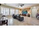 Spacious living room features a stone accent wall with a TV and two large leather chairs at 2571 E Balsam Ct, Chandler, AZ 85286