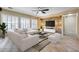Elegant living room featuring neutral tones, a stone accent wall, and ample natural light at 2571 E Balsam Ct, Chandler, AZ 85286