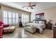 Comfortable main bedroom with tiled floors, shuttered windows and an upholstered bench at the foot of the bed at 2571 E Balsam Ct, Chandler, AZ 85286