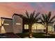 Stylish modern house featuring a well-kept lawn and palm trees, captured against a backdrop of the evening sky at 2642 N Fiesta St, Scottsdale, AZ 85257